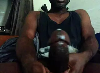 Darkness strokes massive black cock