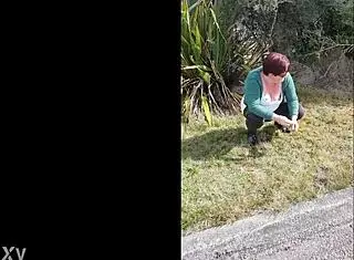 trashy kiwi milf pisses on the roadside with oncoming traffic, showing off her submissive slut side with tattoos and piercings