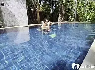 Hot babe swims and teases poolside with couple.