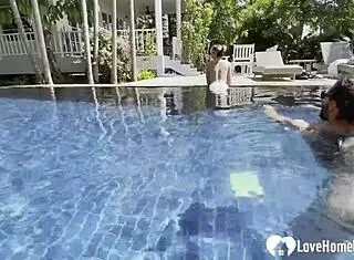 Hot babe swims and teases poolside with couple.