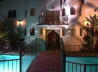 Blonde Mom Bent Over on the Bed. Relaxing After a Long Day.