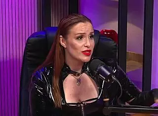Is the redhead milf queen domme licking pussy in bdsm party?