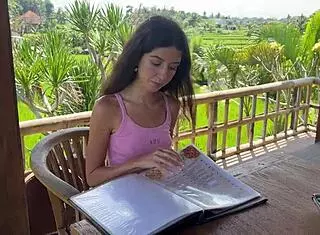 cute girl enjoys burger in public cafe