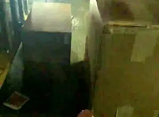 a mexican guy jacking off at his work desk, trying to stay hidden