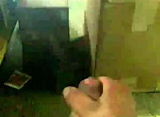 a mexican guy jacking off at his work desk, trying to stay hidden