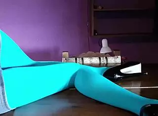 Beautiful Latina MILF shows off her legs in pantyhose and heels on the desk