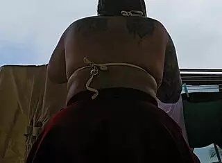 Naughty employee flashes her big ass on the balcony, feeling excited.