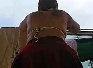 Naughty employee flashes her big ass on the balcony, feeling excited.