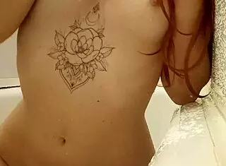 Redhead teen bathing in the shower with tattoos