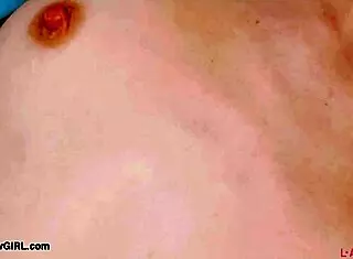 Red-haired model reveals her body in photoshoot.