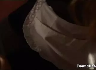 Blonde lesbian slave gets handcuffed to the bed. Her dominant mistress whips her bound body in intense BDSM session.