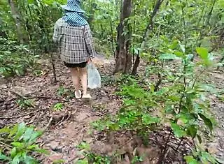 i feel so excited and naughty as this thai teen walks chatting picking mushrooms in the forest showing off cosplay in nature alone