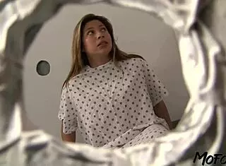 Brunette patient deepthroats big cock through glory hole, swallowing cum with sloppy wet mommy vibes.