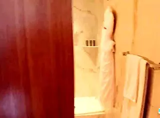 Model engages in intimate encounter inside Hollywood bathroom setting.