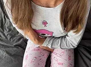 teen in pajamas fingers her shaved pussy to squirt then takes cumshot from a huge cock