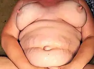 Man pissing on submissive whore with big tits
