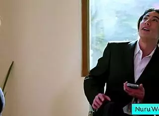 sexy blonde masseuse with big tits and ass explains nuru massage to her client.