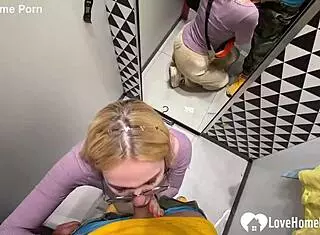 My girlfriend drops to her knees for a blowjob in the changing booth