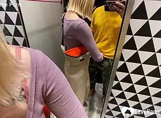 My girlfriend drops to her knees for a blowjob in the changing booth