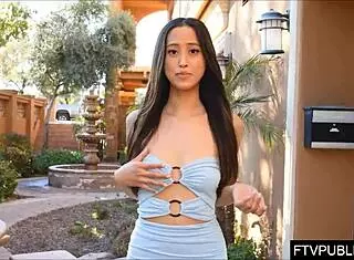 The Asian girl flashed her nude pussy under skirt in public street upskirt without panties.