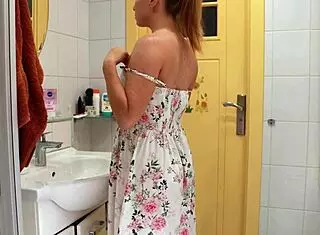 This hot mommy sneaks away to the toilet, hiding as she thrusts a big dildo deep into her wet shaved pussy.