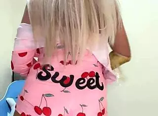 Sexy transsexual in pink pajamas teases with alluring poses and seductive moves in close-up shots