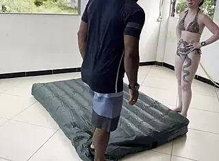 Why can't these two hotties inflate the mattress alone? They get help from a talented man walking by!