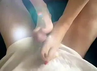 Hey, check out this barefoot goddess giving a hot twinkletoes footjob!