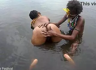 Two tribal lesbians share suggestive river bath