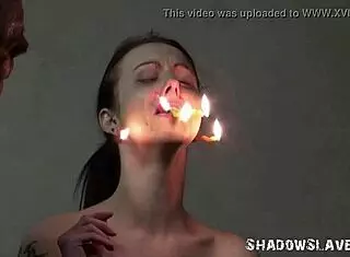 Emily T tied in garage as brutal master punishes slave with burning facial