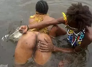Two tribal lesbians share suggestive river bath