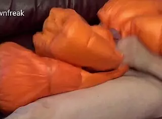 guy humps leather sofa in nylon north face jacket while wanking on bed