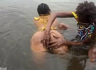 Two tribal lesbians share suggestive river bath