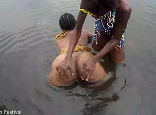 Two tribal lesbians share suggestive river bath