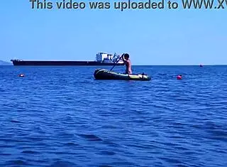 mature bikini babe poses erotically on boat in volga river water