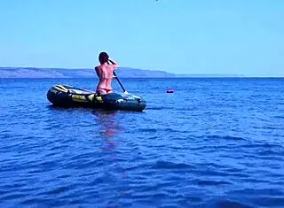 mature bikini babe poses erotically on boat in volga river water