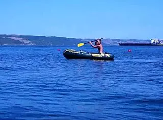 mature bikini babe poses erotically on boat in volga river water