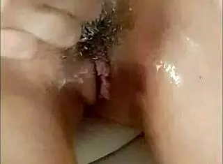 Have you spied on this shy amateur girlfriend shaving her smooth pussy up close?