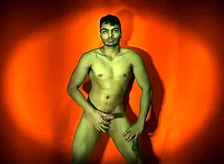 sexy solo guy strokes monster cock on orange backdrop