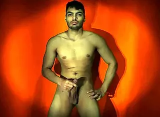 sexy solo guy strokes monster cock on orange backdrop