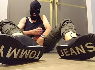 guy strokes cock hard while wearing sneakers