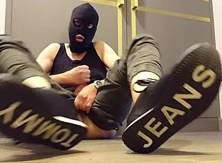 guy strokes cock hard while wearing sneakers