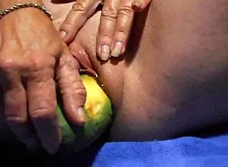 Gaping wet pussy with thick cucumber close-up