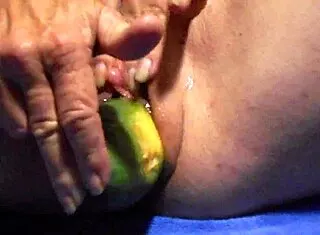 Gaping wet pussy with thick cucumber close-up