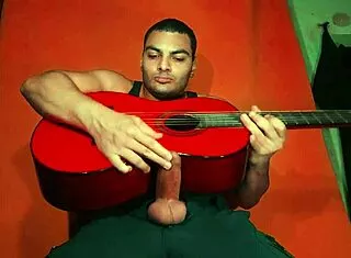 sexy chinese bodybuilder rubs spanish guitar on huge cock over carrot backdrop