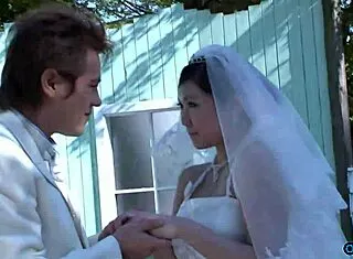 Asian bride in wedding gown fingers pussy while visitor watches