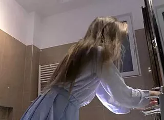 skinny long hair blonde coed lifts miniskirt flashing white cotton panties bathroom