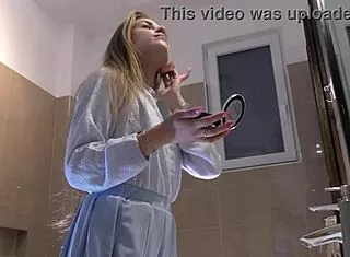 skinny long hair blonde coed lifts miniskirt flashing white cotton panties bathroom