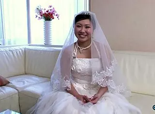 Asian bride in wedding gown fingers pussy while visitor watches