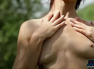 playboy centerfold redhead bombshell strips naked outdoors with old model vibe.